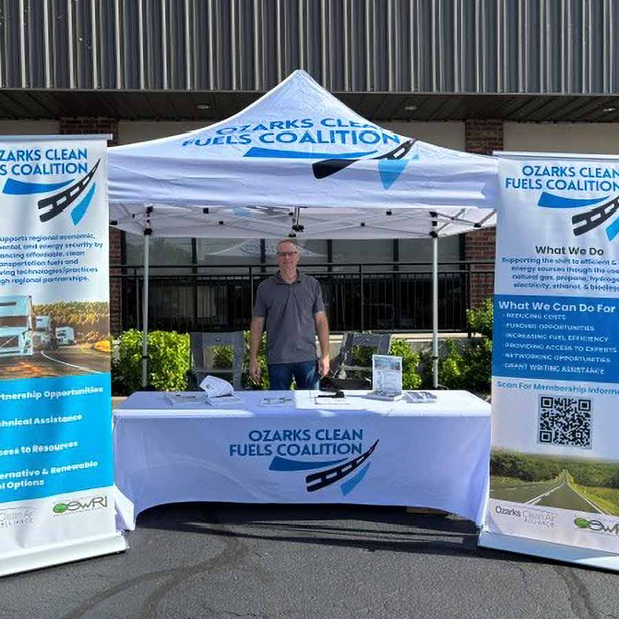 Representative in an Ozarks Clean Fuels Coalition information booth at an event.